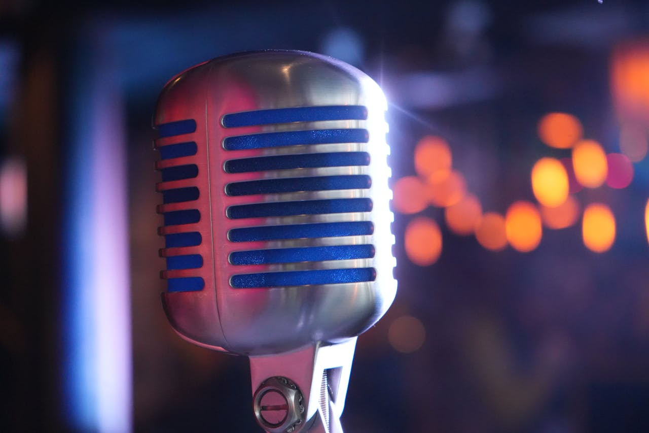 Close-up of a classic microphone with colorful bokeh, ideal for music and performance themes.
